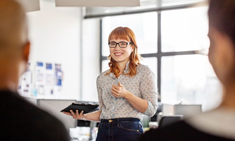 Digital leader standing in front of colleagues